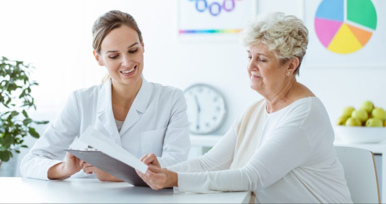 Doctor going over chart with female patient