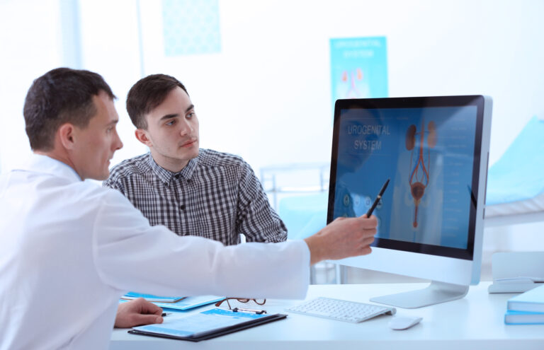 Dcotor explaining images on a computer to a patient